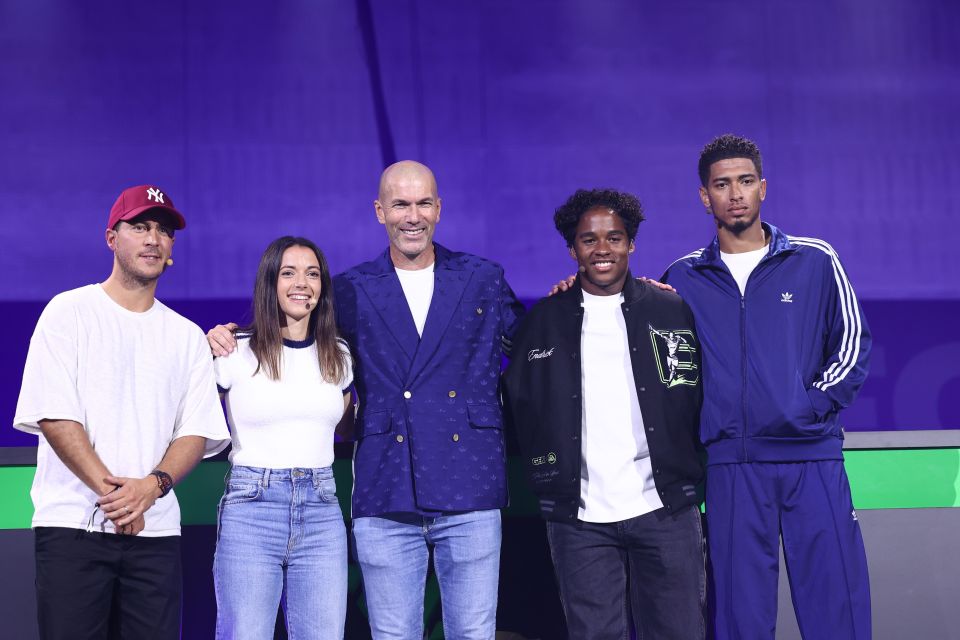 a group of people posing for a picture with one wearing a ny hat