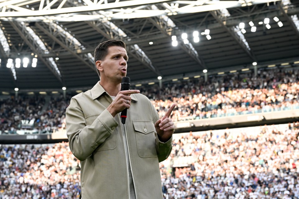 a man speaking into a microphone in front of a crowd