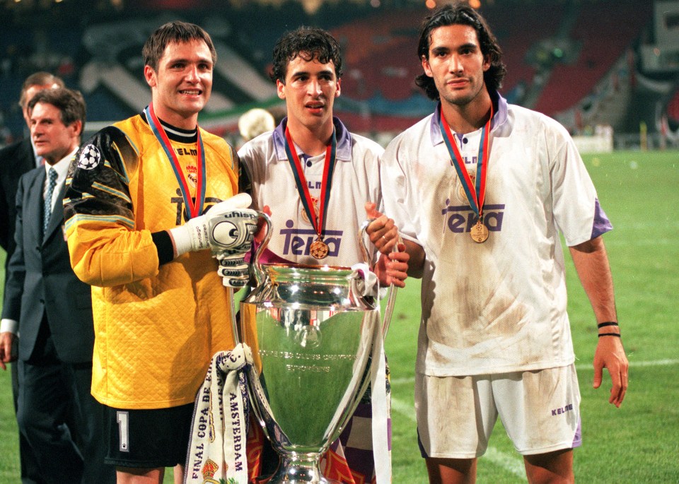 three soccer players holding a trophy with the word tera on their shirts