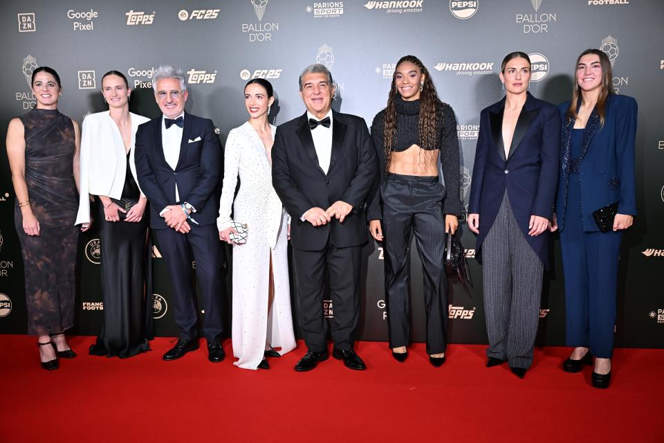 a group of people standing on a red carpet sponsored by pepsi