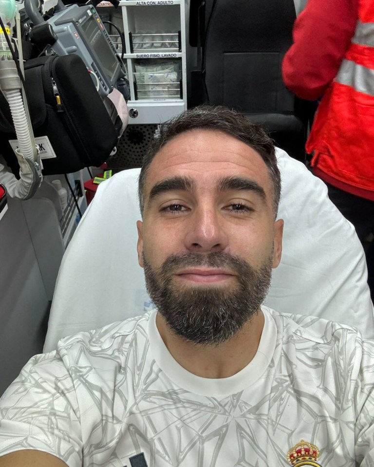a man in an ambulance with a crown on his shirt