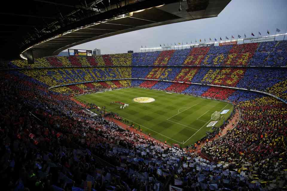 a soccer stadium filled with fans and a banner that says ' fcb ' on it