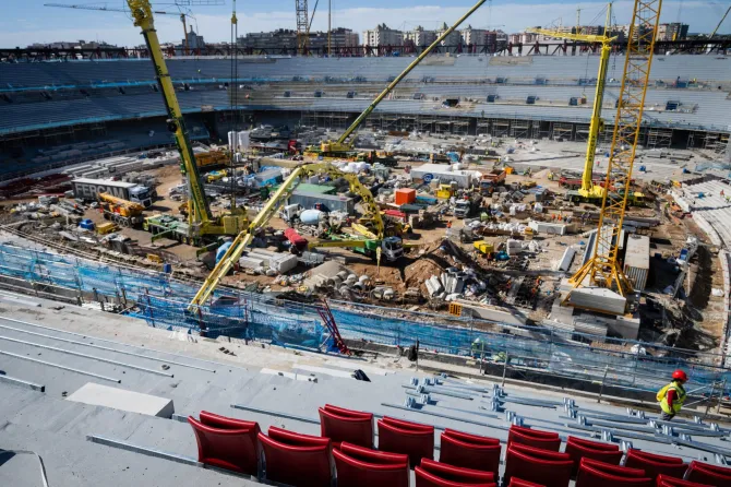 a construction site with a lot of machinery and red seats