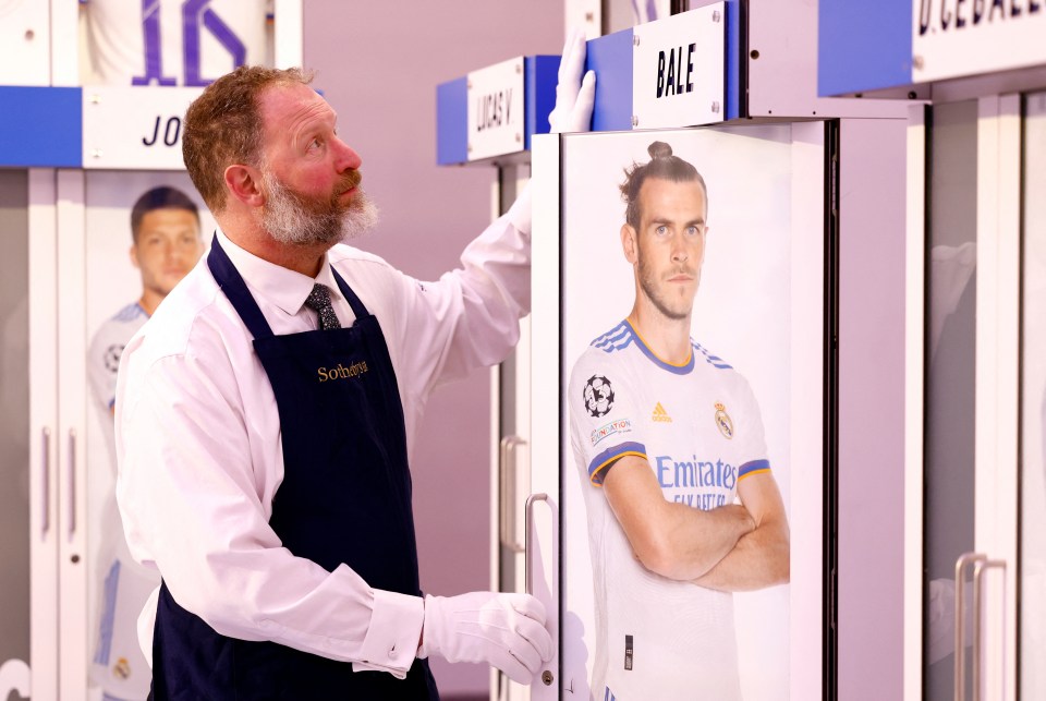 a man wearing an apron that says sotheby 's on it