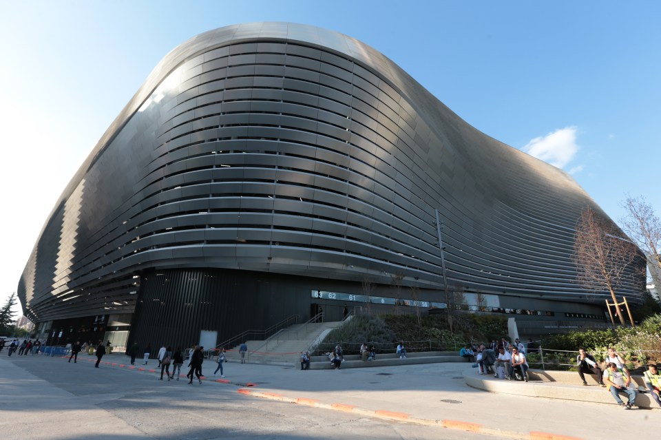 a large building with a curved roof and stairs leading up to it