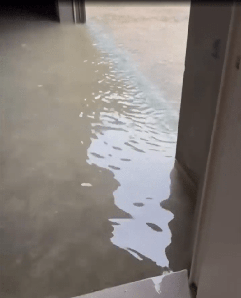 a flooded room with water coming out of a doorway