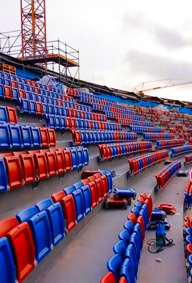 rows of blue and red seats in a stadium