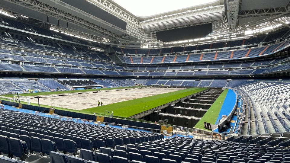 Interior view of the Santiago Bernabéu Stadium in Madrid showing the retractable playing field.