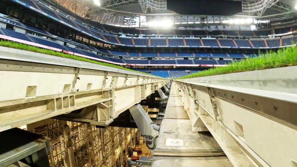 Trays of grass being moved from a football field into the stadium's hypogeum.