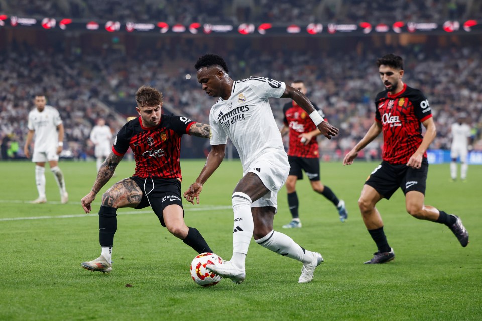 Vinicius Jr of Real Madrid dribbling the ball during a soccer match.