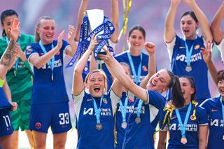 Erin Cuthbert and Niamh Charles lift the WSL trophy