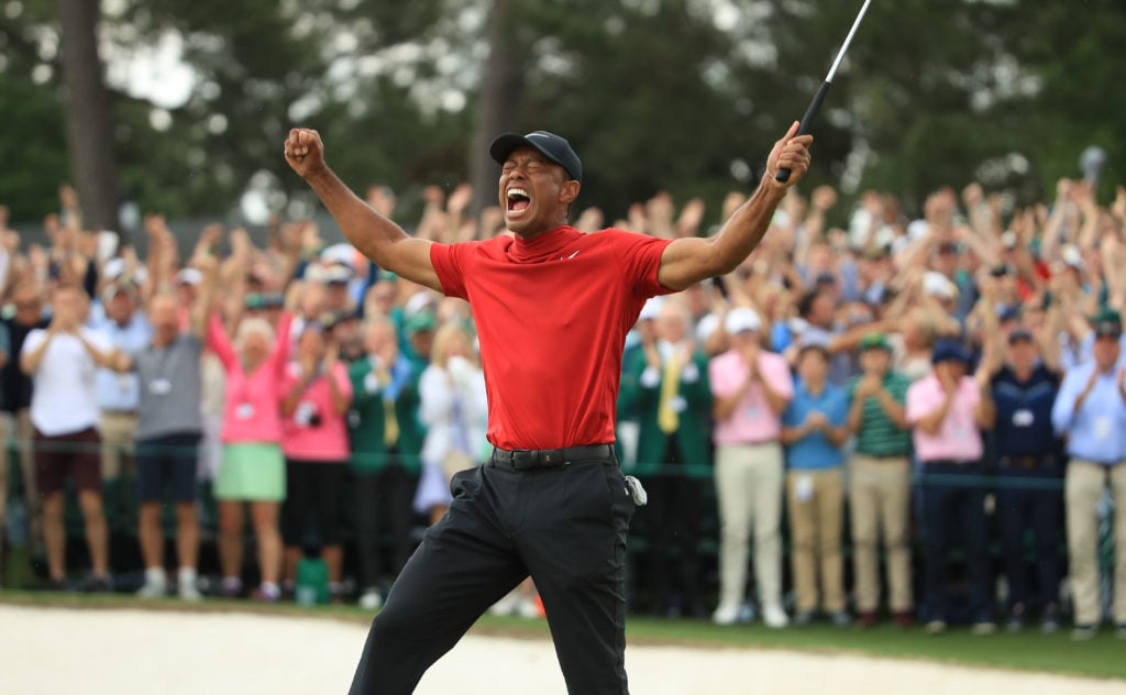 Tiger Woods (L) of the United States celebrates on the 18th green after winning the Masters at Augusta National Golf Club on April 14, 2019 in Augu...