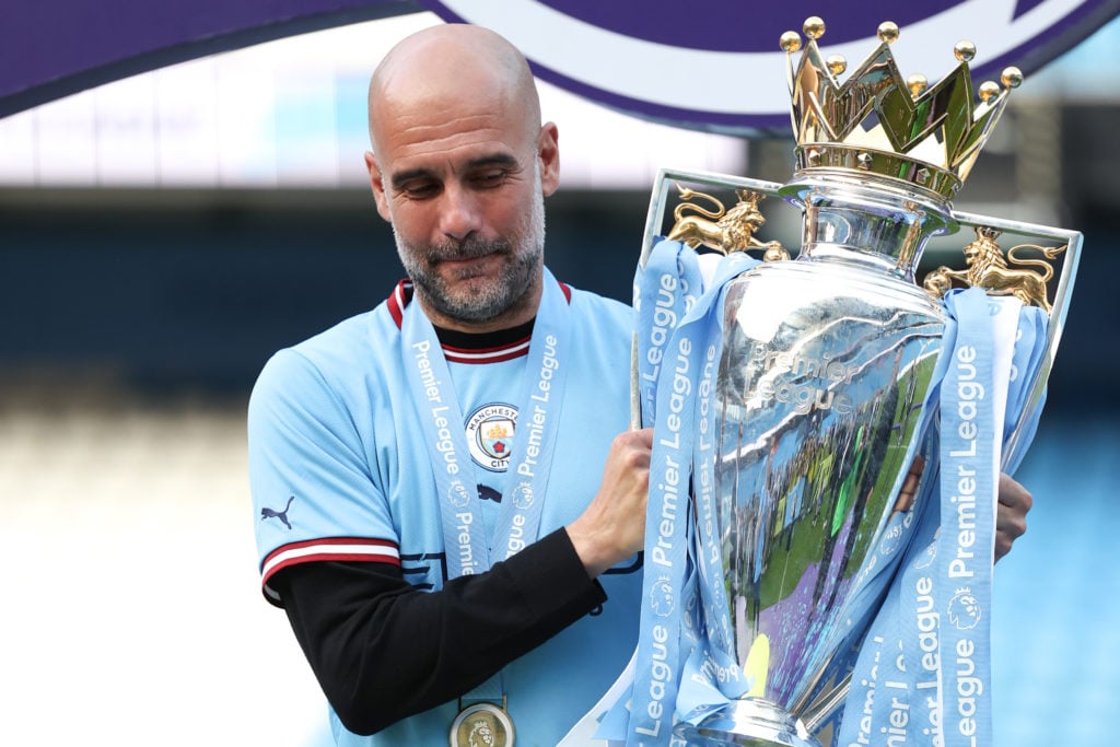 Pep Guardiola the head coach / manager of Manchester City lifts the Premier League trophy  during the Premier League match between Manchester City ...