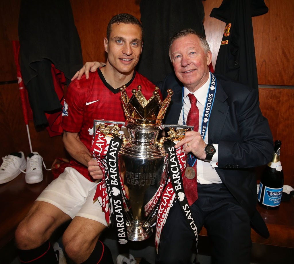 Nemanja Vidic and Manager Sir Alex Ferguson of Manchester United celebrate with the Barclays Premier League trophy in the dressing room after the B...