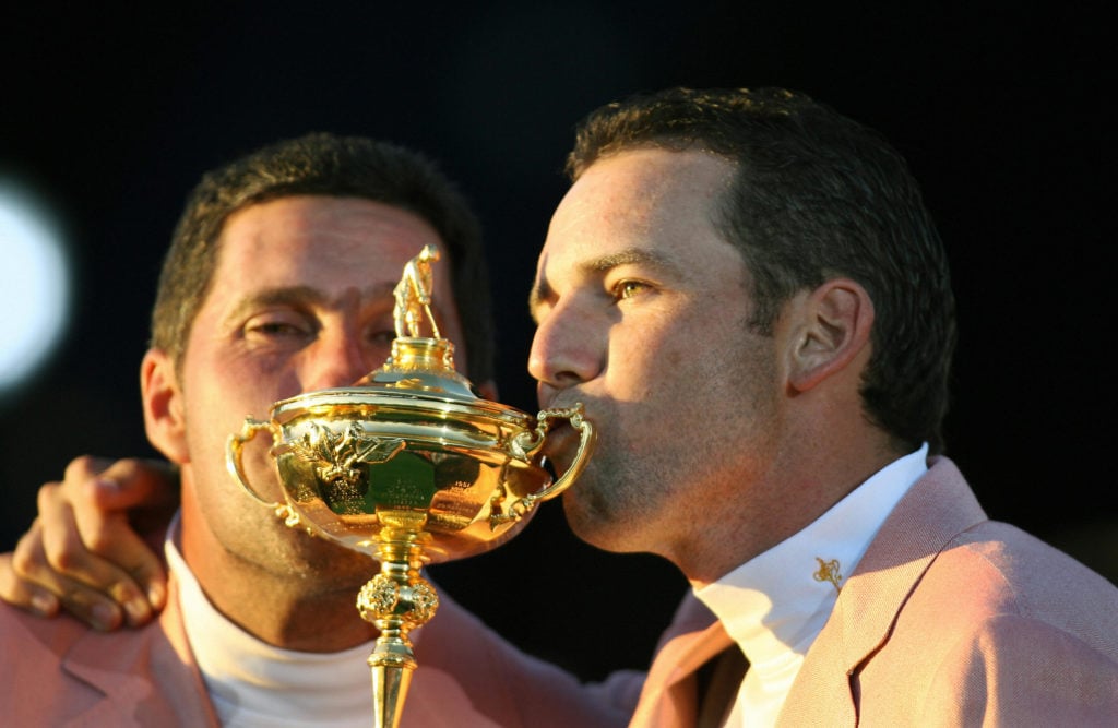 European Ryder Cup players Sergio Garcia (R) and Jose Maria Olazabal kiss the Ryder Cup trophy during the closing ceremony of the 2006 Ryder Cup co...