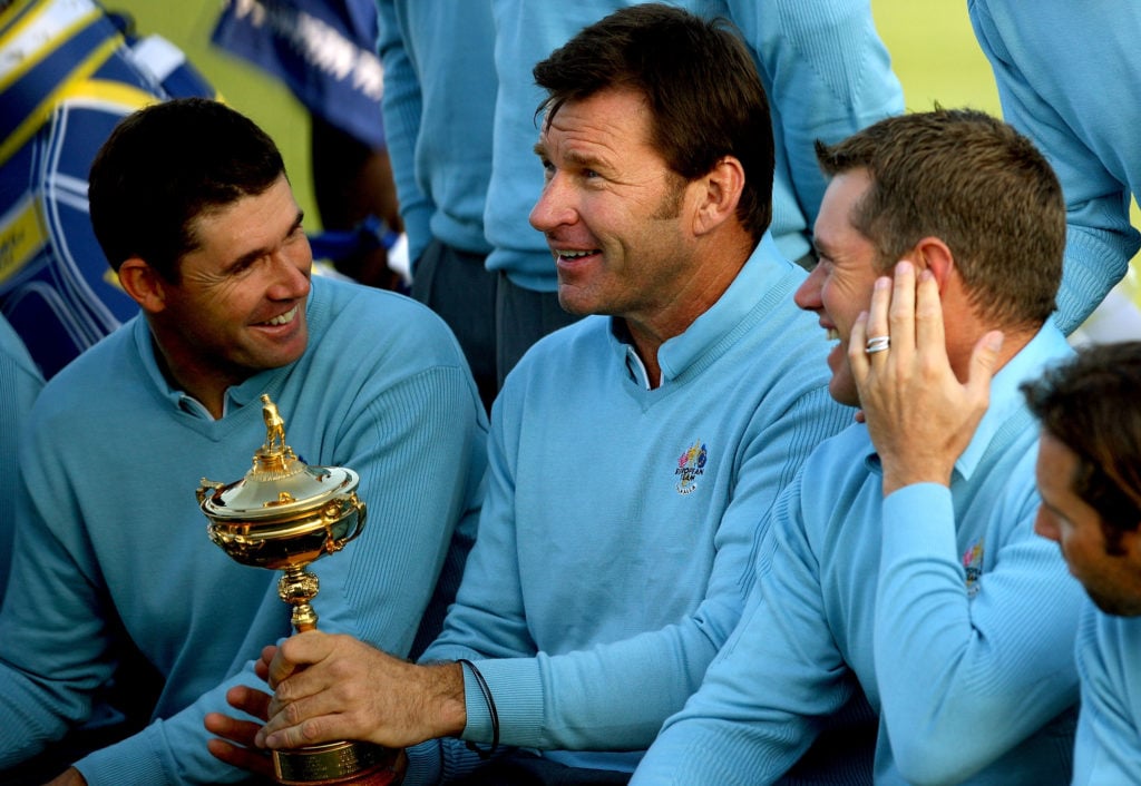 European team captain Nick Faldo holds the trophy as he jokes with Padraig Harrington (L) and Lee Westwood (R) during the European Team photo shoot...