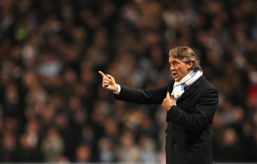 Roberto Mancini the manager of Manchester City gives instructions to his players during the Barclays  Premier League match between Manchester City ...