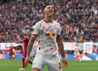 Benjamin Sesko of RB Leipzig celebrates scoring his team's second goal during the Bundesliga match between RB Leipzig and FC Augsburg at Red Bull Arena on September 28, 2024 in Leipzig, Germany.