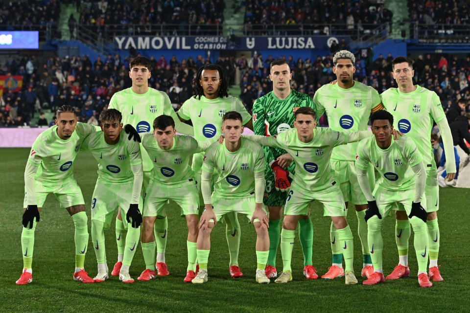 FC Barcelona soccer team lineup in lime green uniforms.