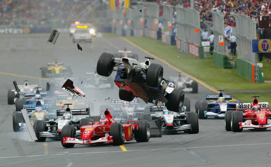 Ralf Schumacher of Germany and the BMW Williams Formula One Team Gets airborne after clipping the Ferrari of Rubens Barrichello at the 2002 Fosters...