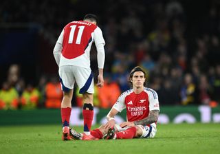 Riccardo Calafiori of Arsenal goes down with a injury as Gabriel Martinelli of Arsenal checks on him during the UEFA Champions League 2024/25 League Phase MD3 match between Arsenal FC and FC Shakhtar Donetsk at Emirates Stadium on October 22, 2024 in London, England.