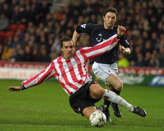 Southampton's Claus Lundekvam clears the ball from Tottenham's Robbie Keane during a game in January 2003.