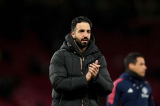 Manchester United head coach Ruben Amorim, wearing a black coat, applauds the fans at the end of the FA Cup fifth round match against Fulham at Old Trafford on 2 March, 2025