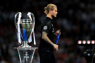 Loris Karius walks past the Champions League trophy following Liverpool's loss to Real Madrid in 2018