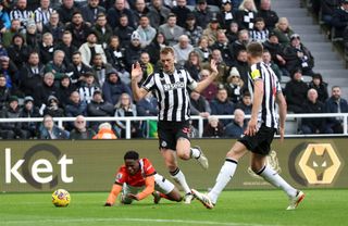 Chiedozie Ogbene of Luton Town clashes with Dan Burn of Newcastle United during the Premier League match between Newcastle United and Luton Town at St. James Park on February 03, 2024 in Newcastle upon Tyne, England