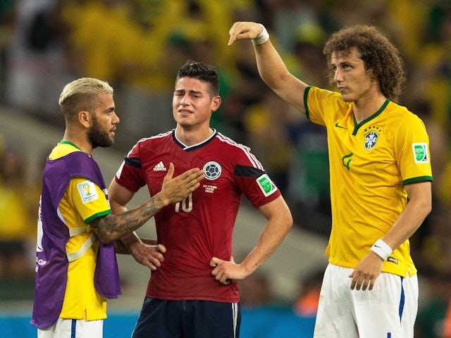 Brazil's Dani Alves and David Luiz console Colombia's James Rodriguez at the 2014 World Cup