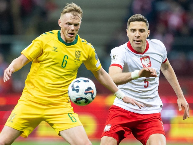 Domantas Antanavicius of Lithuania holds off Jan Bednarek of Poland on March 21, 2025