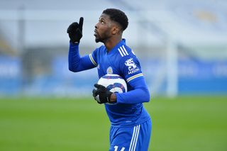 Kelechi Iheanacho walks off with the match ball after scoring a hat-trick for Leicester City against Sheffield United in March 2021.