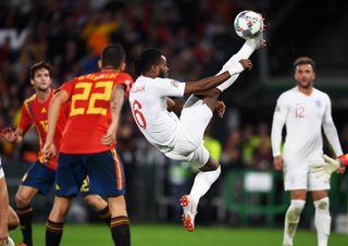 Nathaniel Chalobah clears the ball in a game for England against Spain in October 2018.