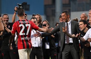 AC Milan technical director Paolo Maldini claps hands with son Daniel Maldini following a game against Sassuolo after the club's Serie A title win in May 2022.