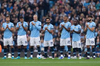 MANCHESTER, ENGLAND - SEPTEMBER 22: Manchester City players Ruben Dias, Rodri, Erling Haaland, Ilkay Gundogan, Manuel Akanji, Jeremy Doku and Josko Gvardiol join in with a minutes applause for Howard Bernstein before the Premier League match between Manchester City FC and Arsenal FC at Etihad Stadium on September 22, 2024 in Manchester, England. (Photo by Visionhaus/Getty Images)