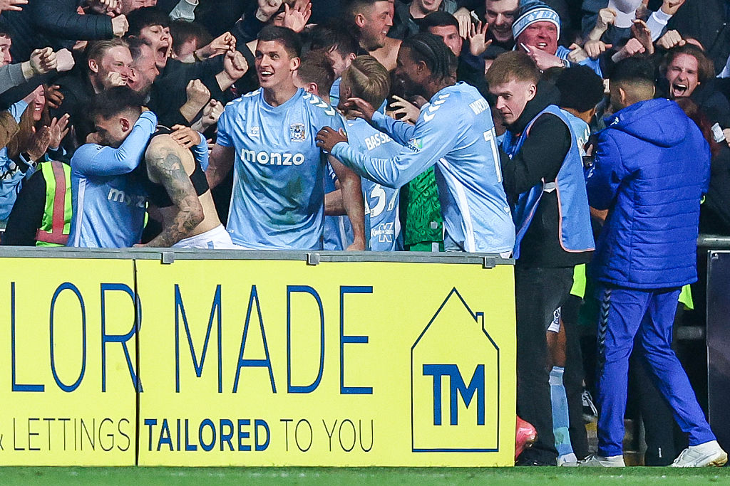 Jamie Paterson of Coventry City, is hugged by #4, Bobby Thomas, as he celebrates his goal in front of the fans during the Sky Bet Championship match between Coventry City and Portsmouth at the Coventry Building Society Arena in Coventry, on April 9, 2025.