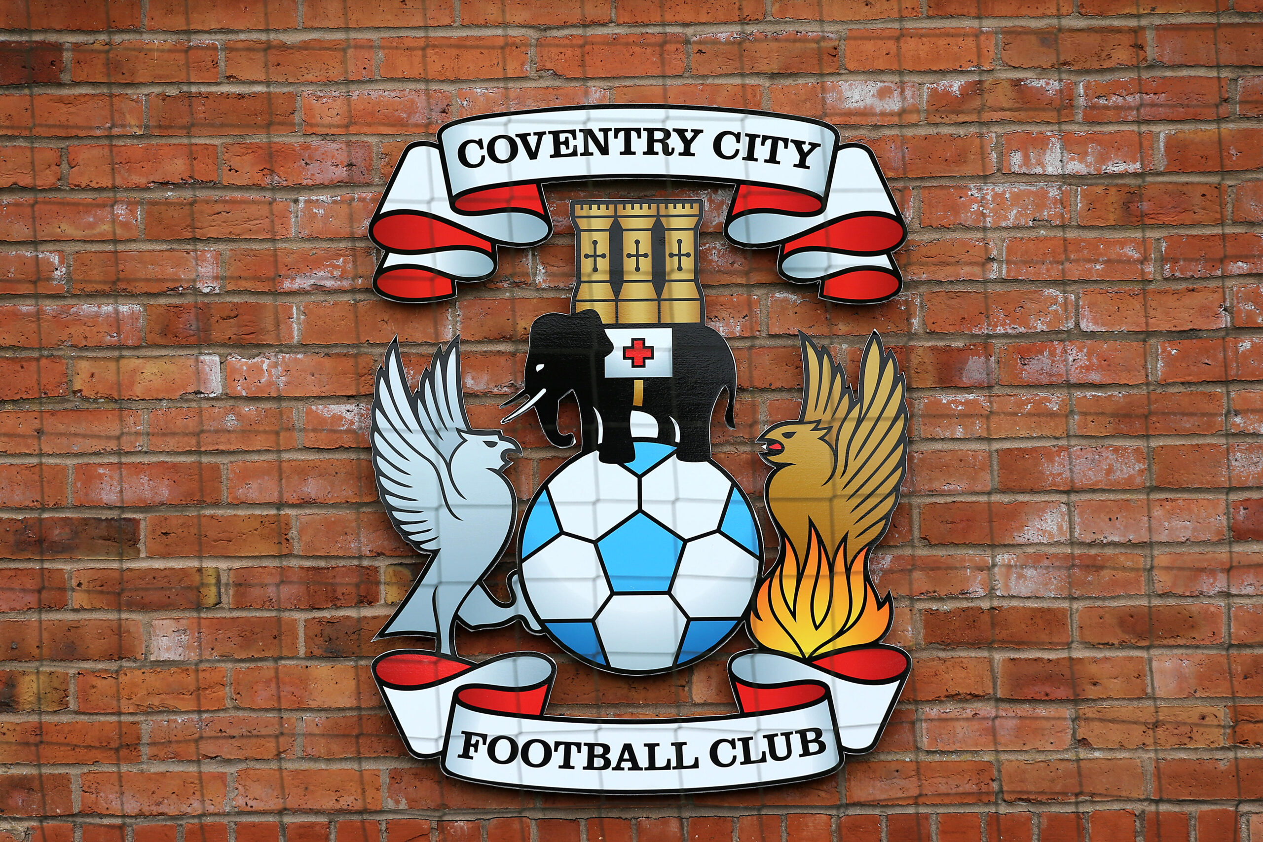 The Coventry City badge on a wall at the club's training ground