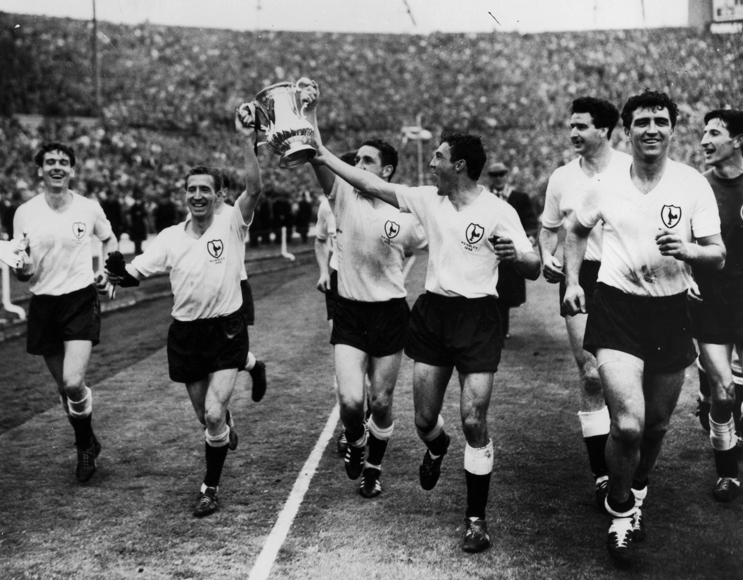 Tottenham players celebrate with the FA Cup after beating Burnley 3-1 in the 1962 final at Wembley.