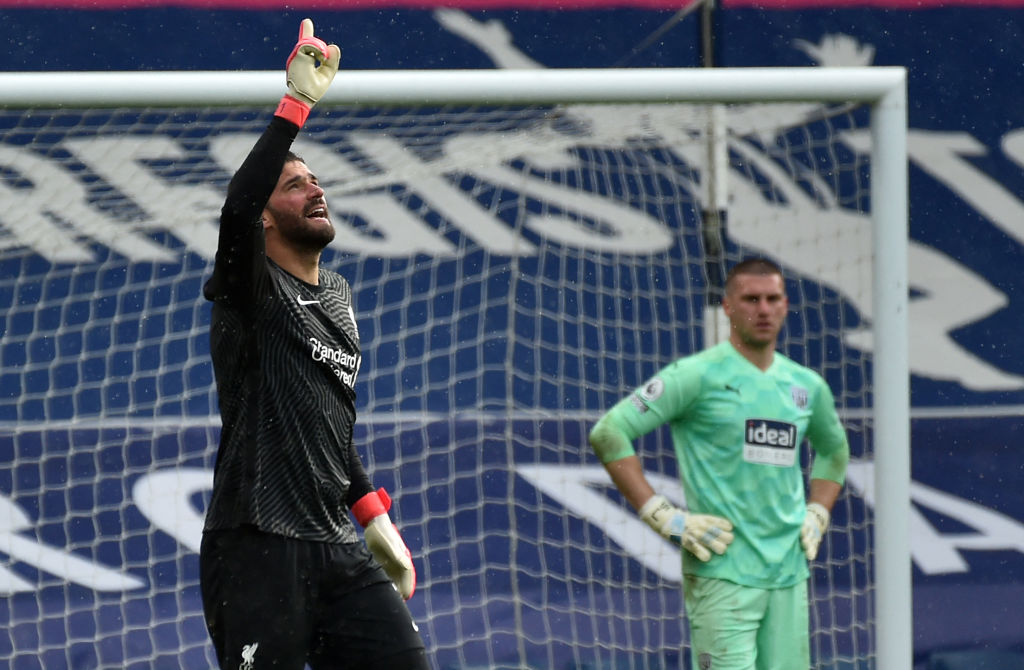Liverpool's Brazilian goalkeeper Alisson Becker celebrates scoring his team's second goal with teammates during the English Premier League football match between West Bromwich Albion and Liverpool at The Hawthorns stadium in West Bromwich, central England, on May 16, 2021. - - RESTRICTED TO EDITORIAL USE. No use with unauthorized audio, video, data, fixture lists, club/league logos or 'live' services. Online in-match use limited to 120 images. An additional 40 images may be used in extra time. No video emulation. Social media in-match use limited to 120 images. An additional 40 images may be used in extra time. No use in betting publications, games or single club/league/player publications. (Photo by Tim Keeton / POOL / AFP) / RESTRICTED TO EDITORIAL USE. No use with unauthorized audio, video, data, fixture lists, club/league logos or 'live' services. Online in-match use limited to 120 images. An additional 40 images may be used in extra time. No video emulation. Social media in-match use limited to 120 images. An additional 40 images may be used in extra time. No use in betting publications, games or single club/league/player publications. / RESTRICTED TO EDITORIAL USE. No use with unauthorized audio, video, data, fixture lists, club/league logos or 'live' services. Online in-match use limited to 120 images. An additional 40 images may be used in extra time. No video emulation. Social media in-match use limited to 120 images. An additional 40 images may be used in extra time. No use in betting publications, games or single club/league/player publications. (Photo by TIM KEETON/POOL/AFP via Getty Images)