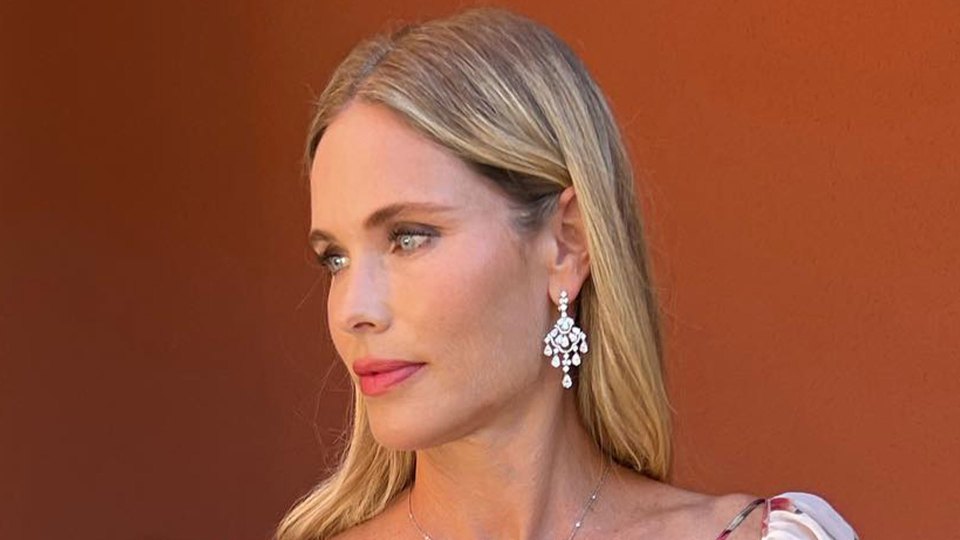 Woman wearing diamond earrings.