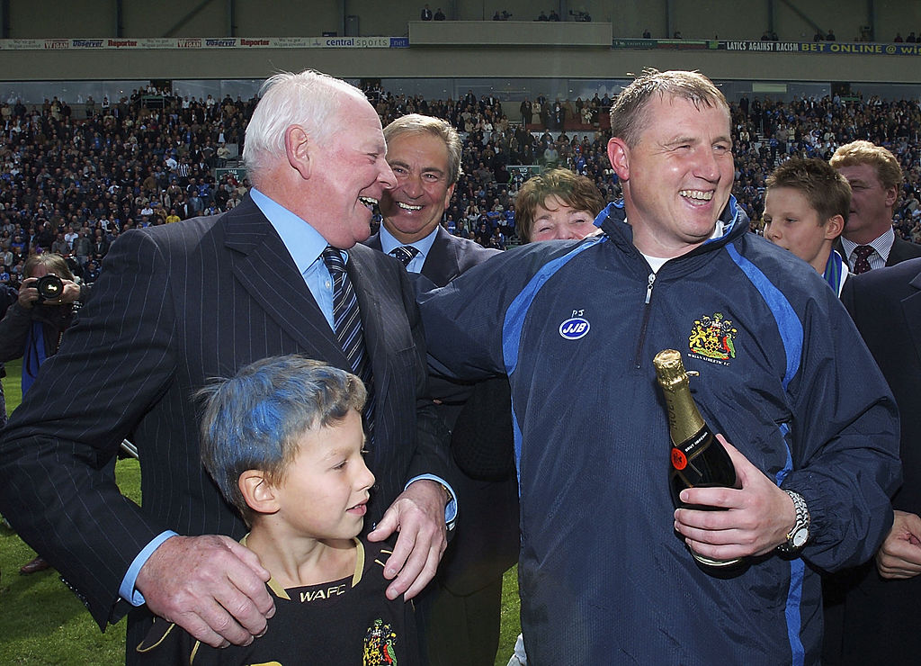 WIGAN, ENGLAND - MAY 8: David Whelan, chairman of Wigan Athletic (L), celebrates with manager Paul Jewell, after they went up to the Premiership during the Coca-Cola Championship match between Wigan Athletic and Reading at the JJB Stadium on May 8, 2005 in Wigan, England. (Photo by Matthew Lewis/Getty Images)