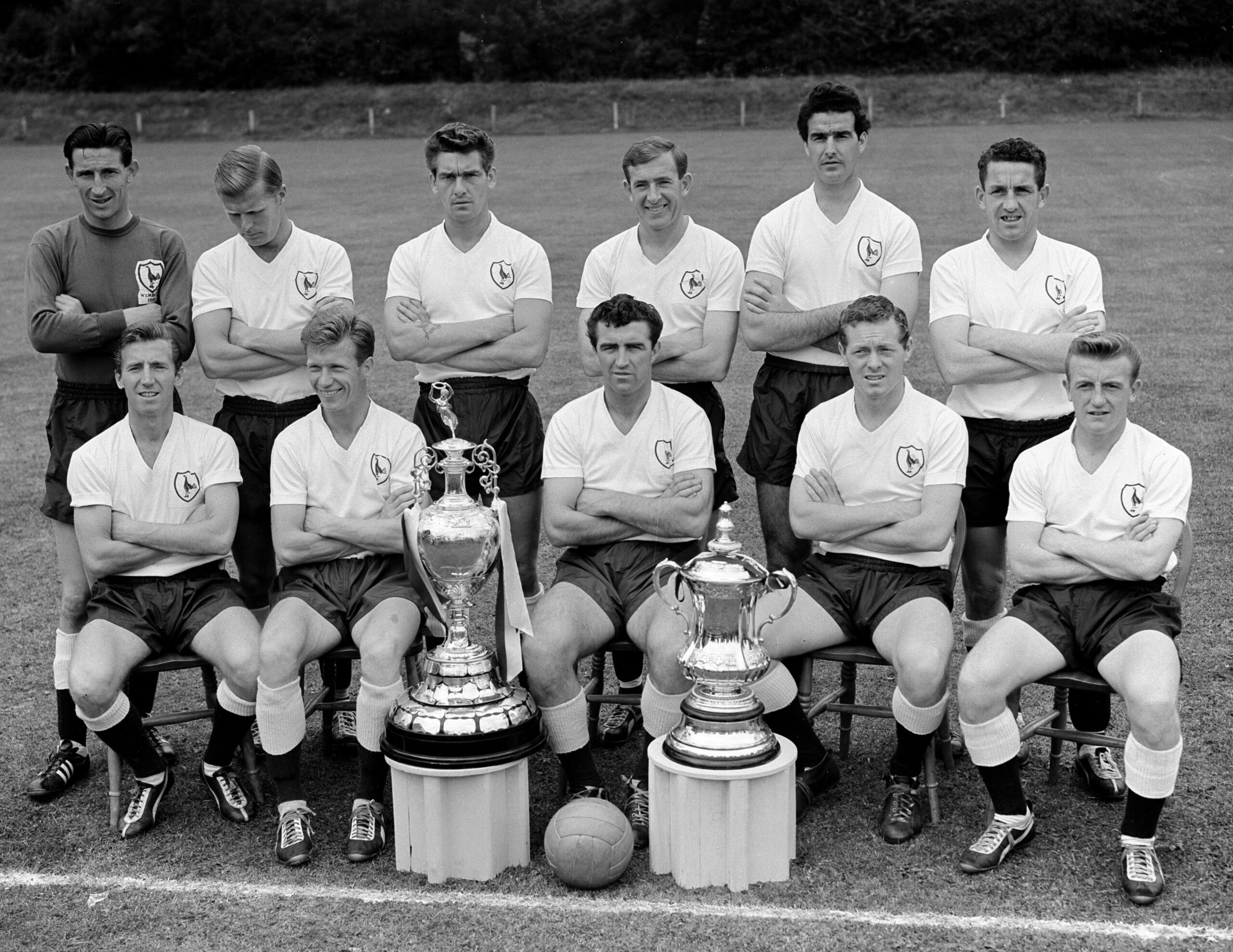 Tottenham Hotspur players pose with the First Division and FA Cup trophies after winning the double in 1960/61.