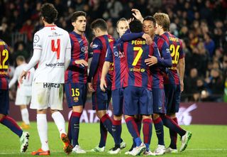 Barcelona players celebrate a Pedro goal against Huesca in the Copa del Rey at Camp Nou in December 2014.