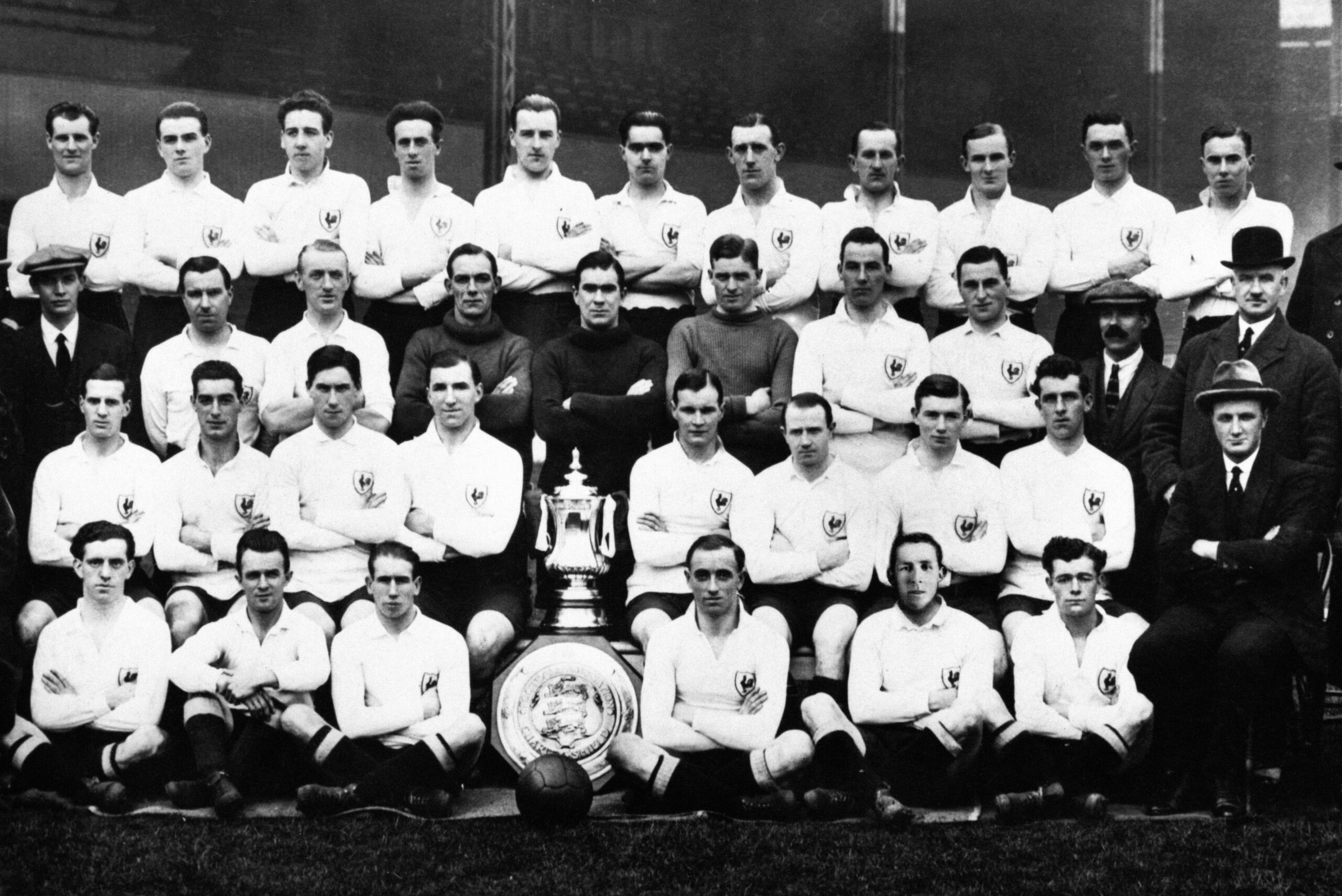 Tottenham's squad pose with the FA Cup and the Charity Shield in 1921.
