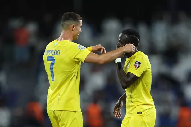 Sadio Mane and Cristiano Ronaldo celebrating with each other on the pitch