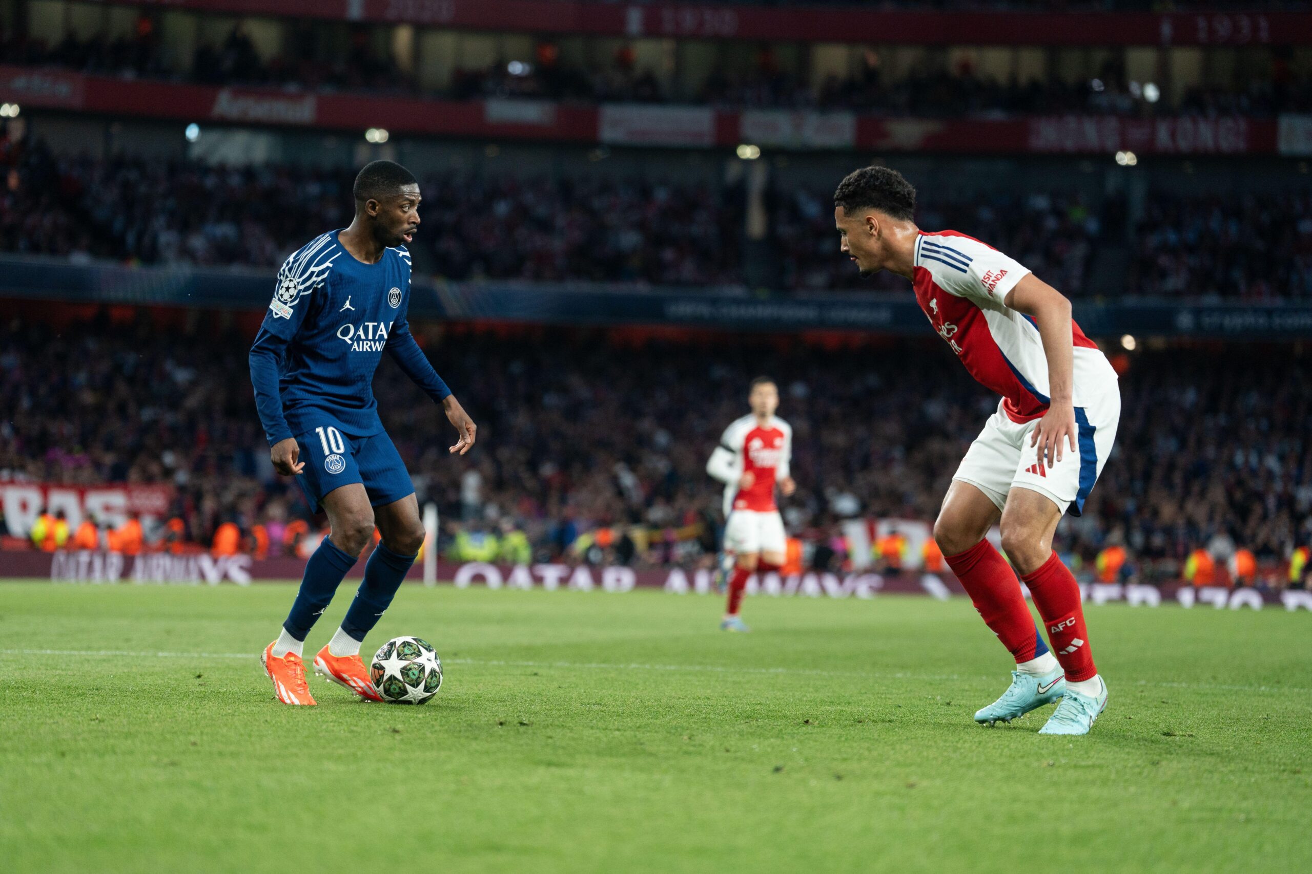 PSG's Ousmane Dembele takes on Arsenal's William Saliba during the 2024/25 Champions League quarter-finals.