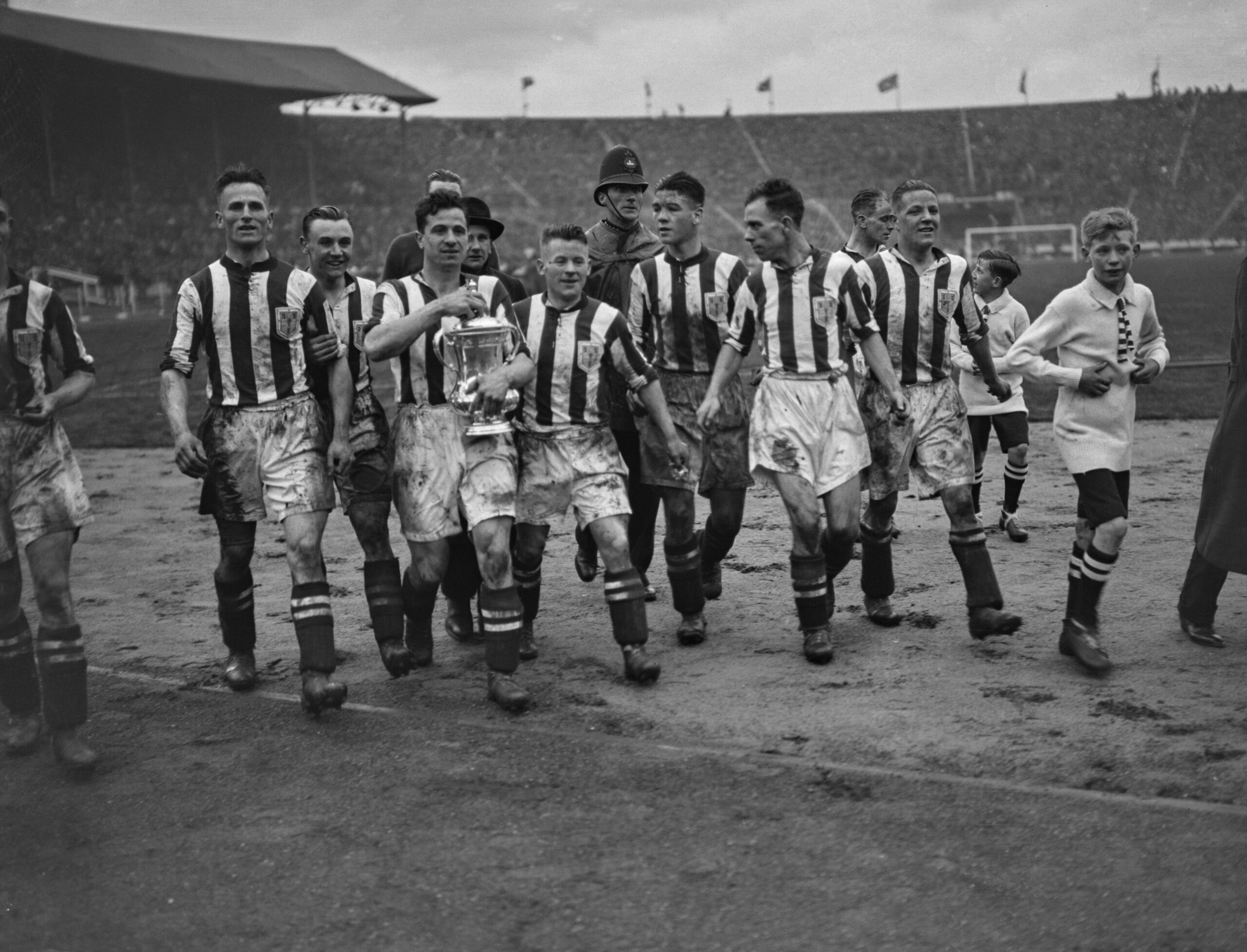 West Brom players celebrate with the FA Cup after victory in the final over Birmingham City in April 1931.