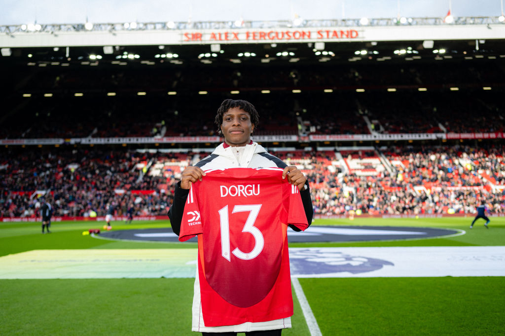 MANCHESTER, ENGLAND - FEBRUARY 02: New signing Patrick Dorgu of Manchester United poses on the pitch ahead of the Premier League match between Manchester United FC and Crystal Palace FC at Old Trafford on February 02, 2025 in Manchester, England. (Photo by Ash Donelon/Manchester United via Getty Images)