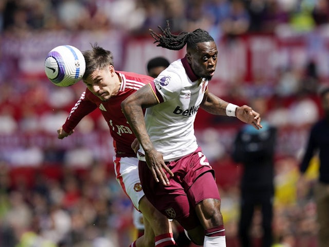 Aaron Wan-Bissaka of West Ham United competes with Manchester United's Manuel Ugarte on May 11, 2025