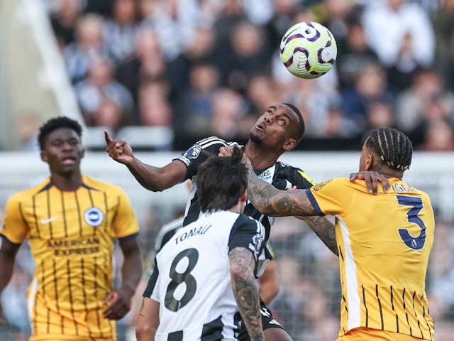 Alexander Isak of Newcastle United jumps up to win the high ball from Igor of Brighton & Hove Albion on October 19, 2024